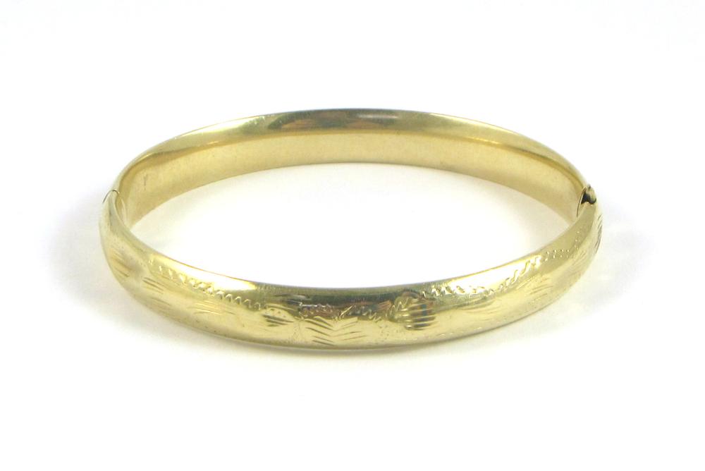 Appraisal: FOURTEEN KARAT GOLD BANGLE engraved exterior grams