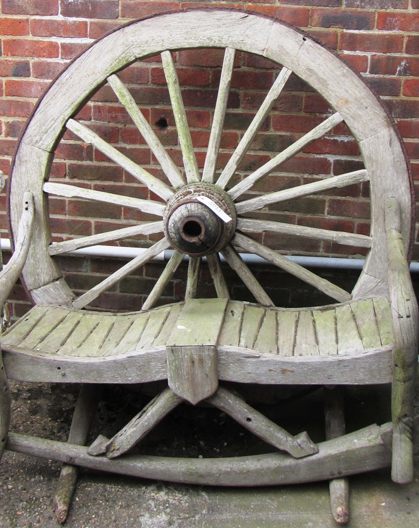 Appraisal: A hardwood garden bench the back formed as a cart