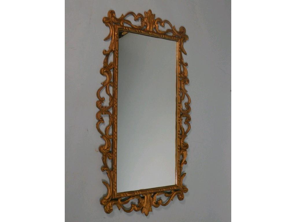 Appraisal: A gilt gesso rectangular wall mirror with a pierced frame