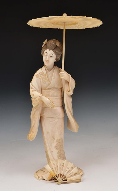 Appraisal: A Japanese ivory okimono of a standing GeishaMeiji periodSigned Meiichi