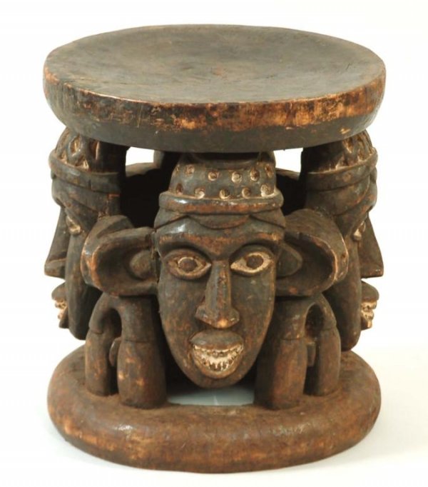 Appraisal: African chief's stool of wood carved with three heads having