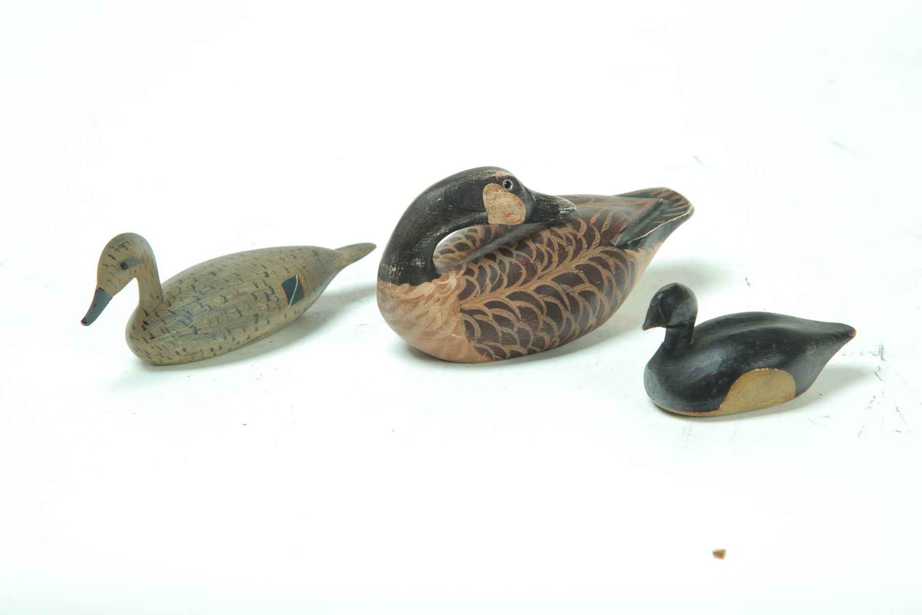 Appraisal: THREE MINIATURE DUCK CARVINGS American nd half- th century Original