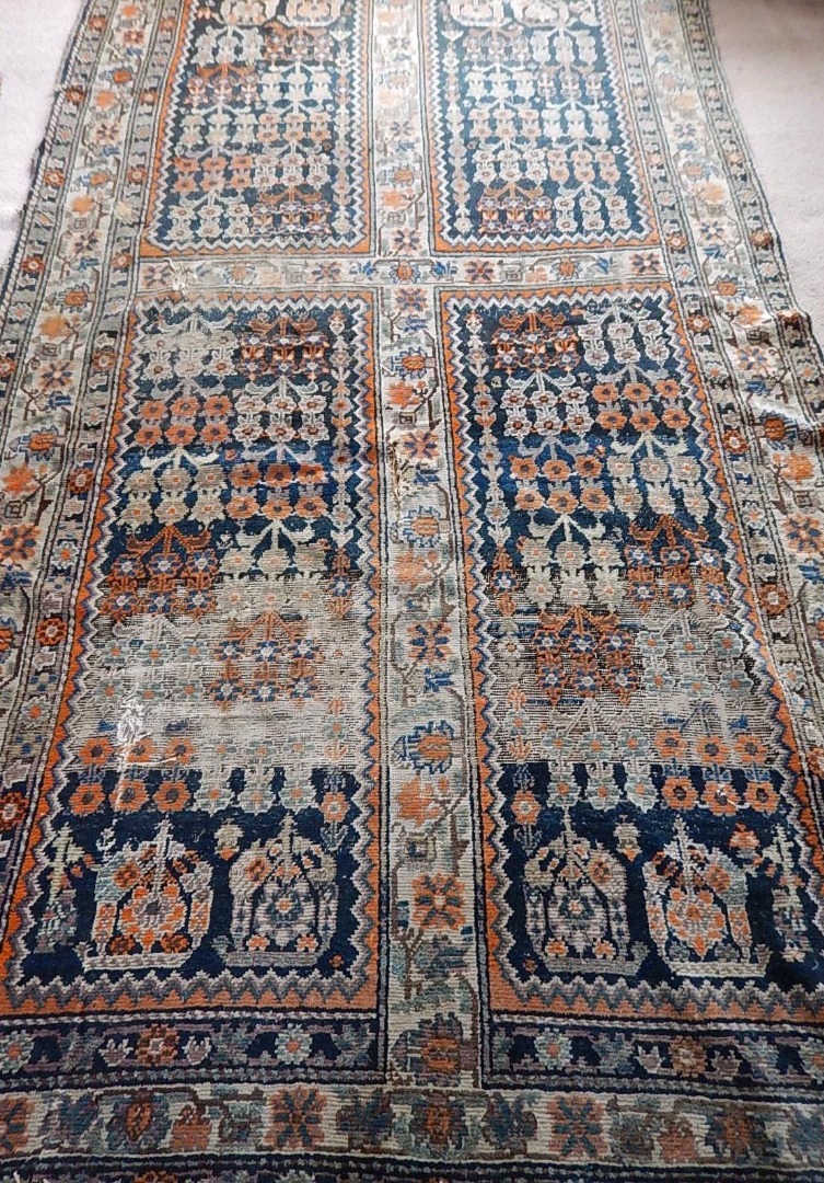 Appraisal: An Iranian bordered rug with four central panels in blue