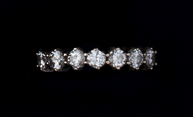 Appraisal: A DIAMOND HALF HOOP RING claw set with a line