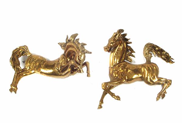 Appraisal: A pair of brass wall plaques of rearing horses height