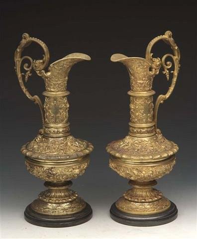 Appraisal: A PAIR OF GILT BRONZE CLASSICAL EWERS with scroll handles