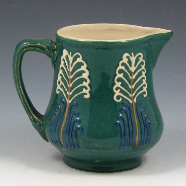 Appraisal: Avon Faience cream pitcher with squeezebag-decorated stylized trees on a