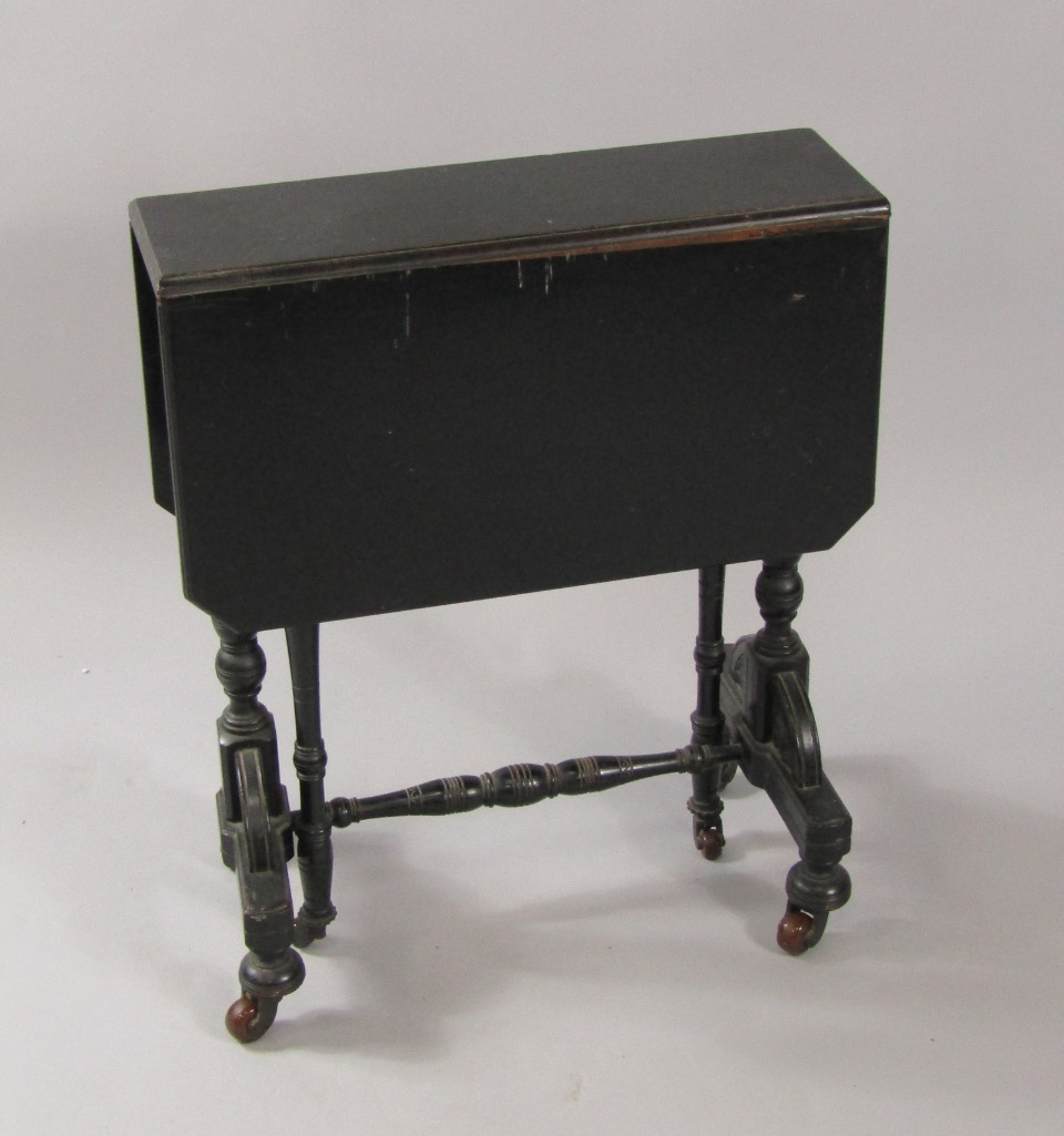 Appraisal: A Victorian ebonised Sutherland table raised on turned legs and