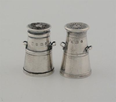 Appraisal: A pair of Edwardian novelty pepperettes in the form of