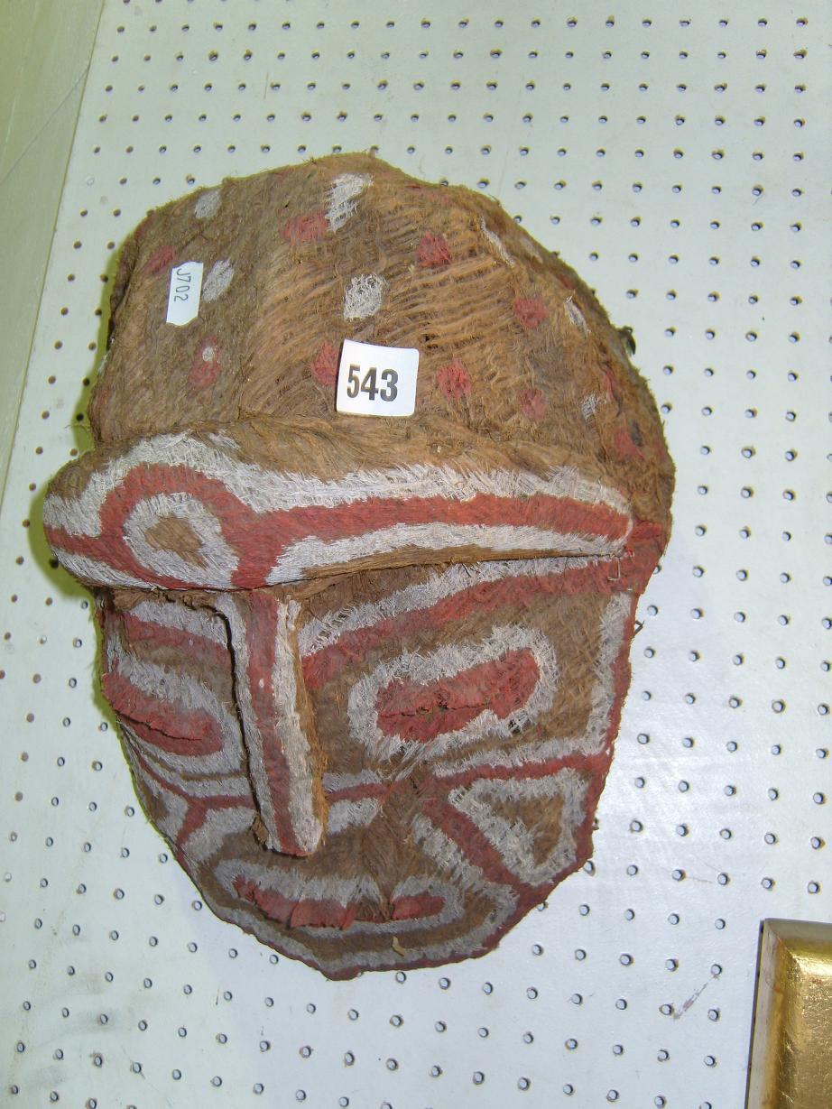 Appraisal: An African Tribal woven mask with painted decoration in red