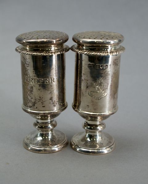 Appraisal: A pair of Edwardian sterling silver pedestal pepper castors Maker