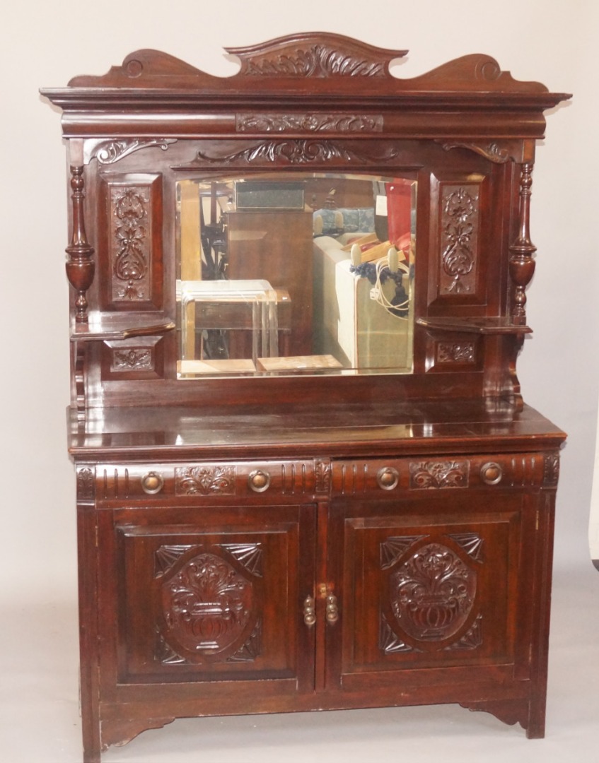 Appraisal: A late thC carved walnut sideboard the raised mirrored back