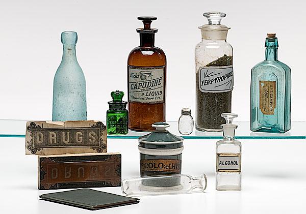 Appraisal: ASSEMBLED SET OF PHARMACY BOTTLES AND ADVERTISING PLUS STUDENT'S BOOK