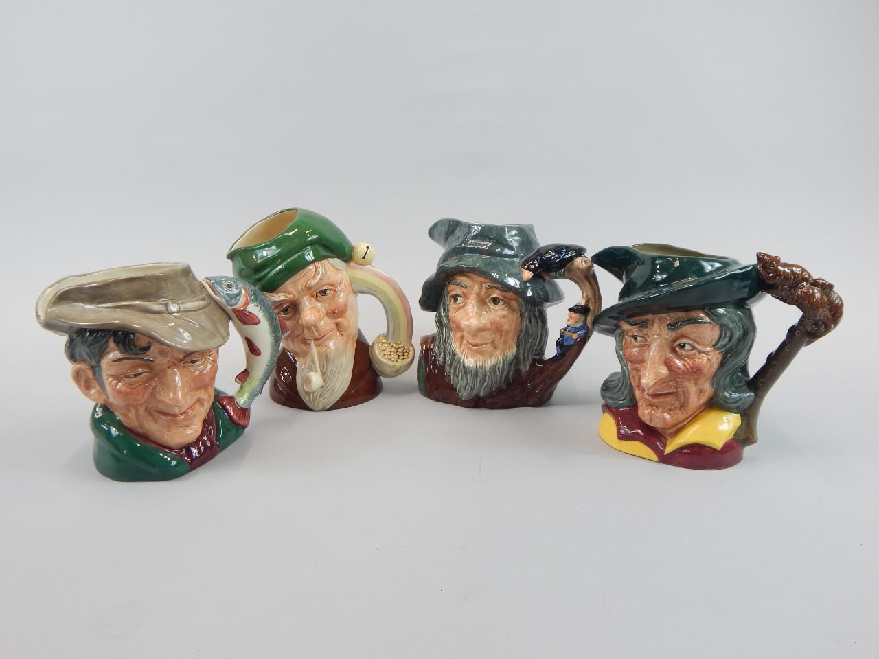 Appraisal: A set of four Royal Doulton large character jugs Leprechaun