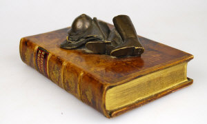 Appraisal: A composition paperweight modelled as a leather book 'Country Pursuits'