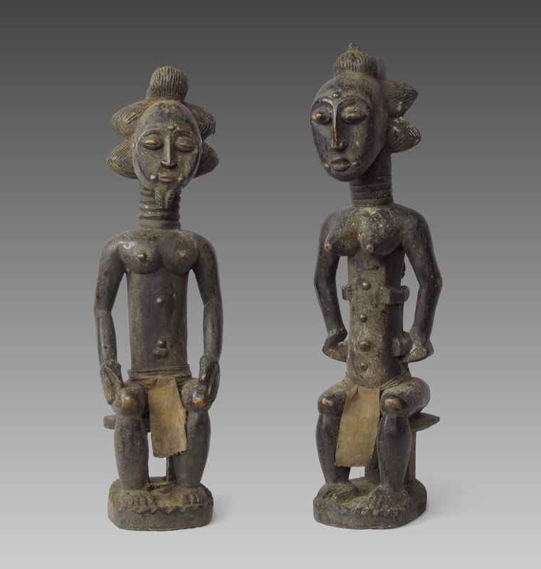 Appraisal: PAIR OF AFRICAN WOODEN BAULE SEATED FIGURES From the Ivory