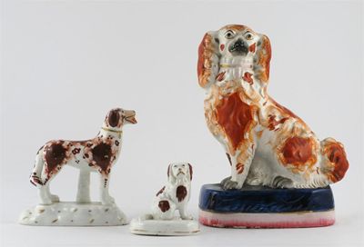 Appraisal: Three Staffordshire models of dogs one standing two Spaniels seated