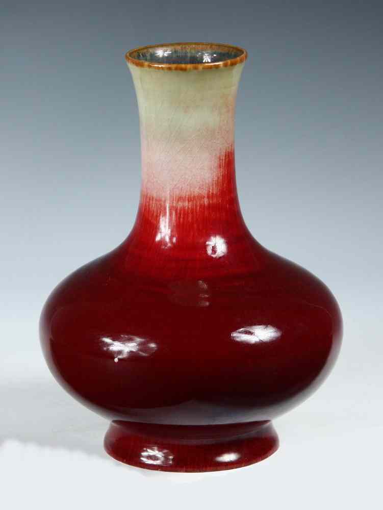 Appraisal: CHINESE POTTERY VASE - Oxblood over celadon glazed squatty ovoid