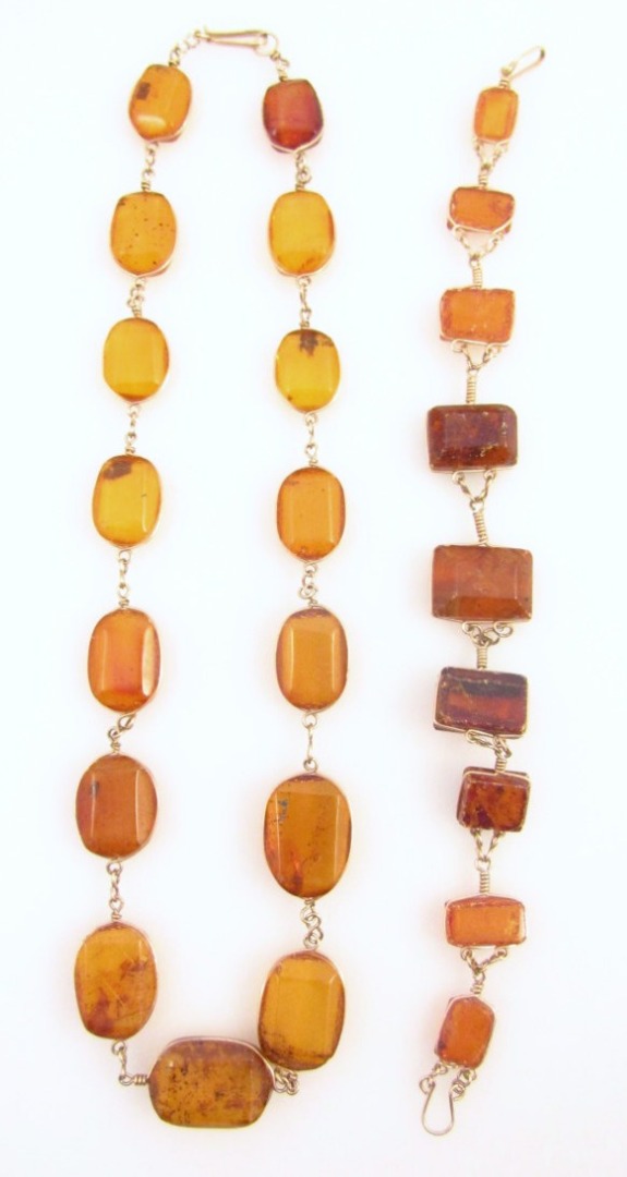 Appraisal: A Baltic amber finish necklace set with various pieces on