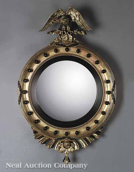 Appraisal: A Regency Giltwood and Ebonized Convex Mirror early th c