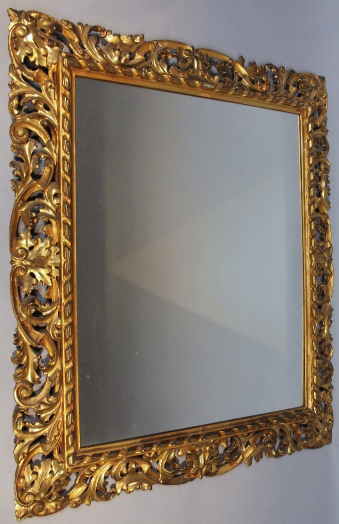 Appraisal: A thC gilt wood mirror in the baroque style pierced