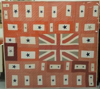 Appraisal: Union Jack and Blue Stars applique quilt stretched and in