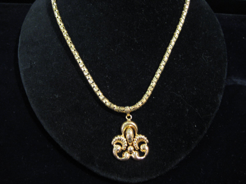 Appraisal: MEDALLION AND CHAIN k yellow gold polished and fluted pendant