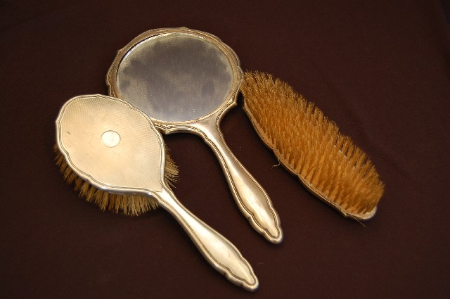 Appraisal: THREE PIECE SILVER MOUNTED MIRROR AND BRUSH SET