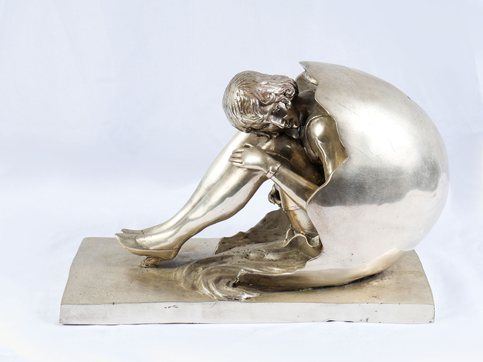 Appraisal: SILVERED BRONZE DECO STYLE SCULPTURE OF A FLAPPER EMERGING FROM