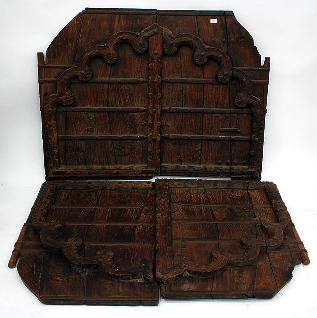 Appraisal: TWO PAIRS OF INDIAN CARVED HARDWOOD IRON STRAPWORK MOUNTED SHUTTERS