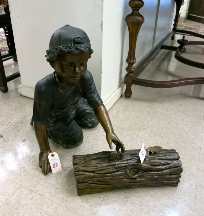 Appraisal: A FIGURAL BRONZE SCULPTURE young boy in kneeling pose observing