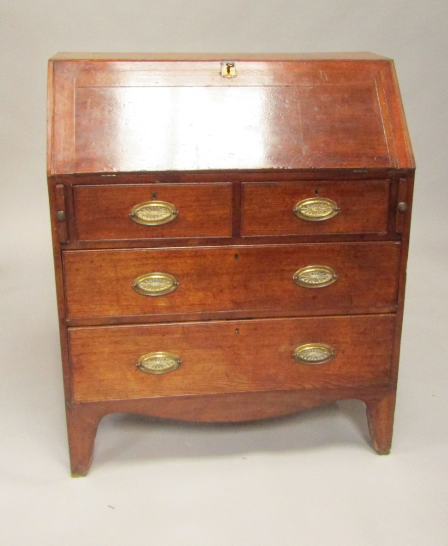 Appraisal: A George III oak bureau the fall flap opening to