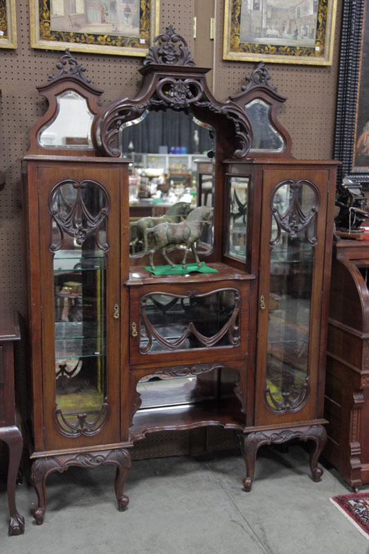 Appraisal: ETEGERE Ornately carved and mirrored etegere in walnut having three