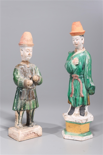 Appraisal: Two Chinese Ming dynasty glazed pottery standing attendants one with