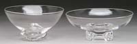 Appraisal: TWO CLEAR FOOTED BOWLS BY STEUBEN One with four scrolled