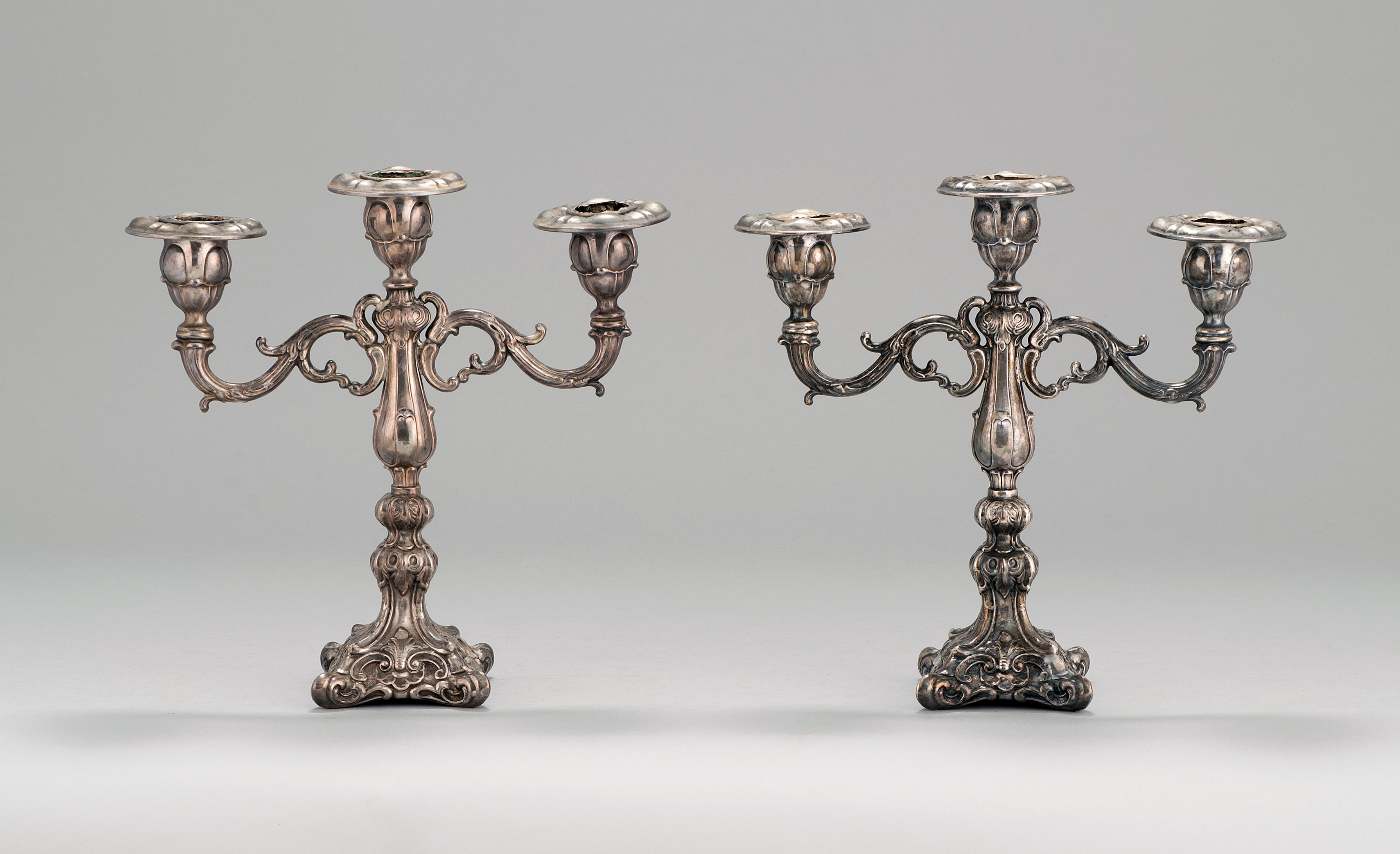 Appraisal: PAIR OF STERLING SILVER PERUVIAN THREE-SOCLE CANDELABRA With stepped shafts