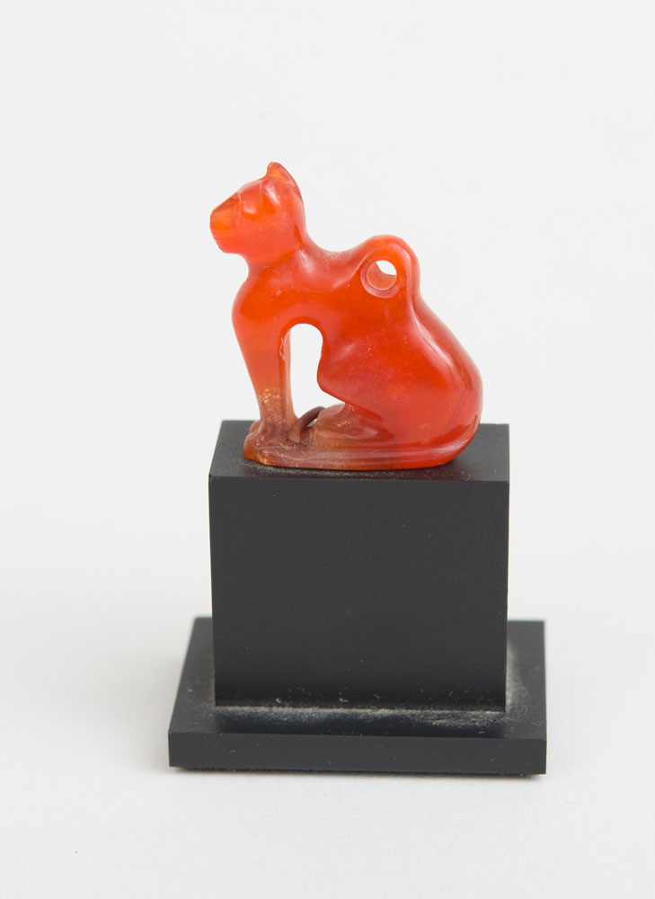 Appraisal: EGYPTIAN CARVED CARNELIAN CAT AMULET Raised on a stand x