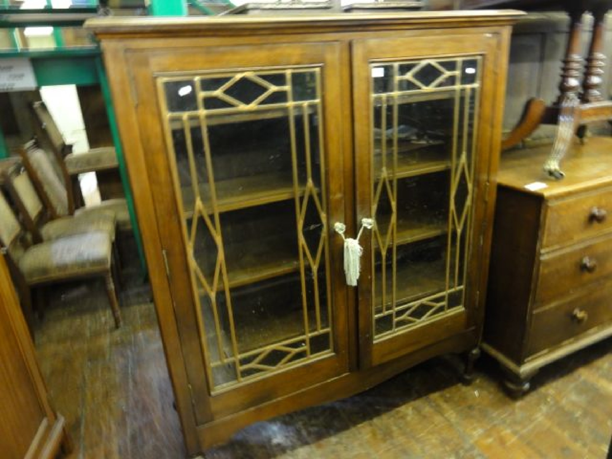 Appraisal: A mahogany side cupboard with glazed and panelled doors on