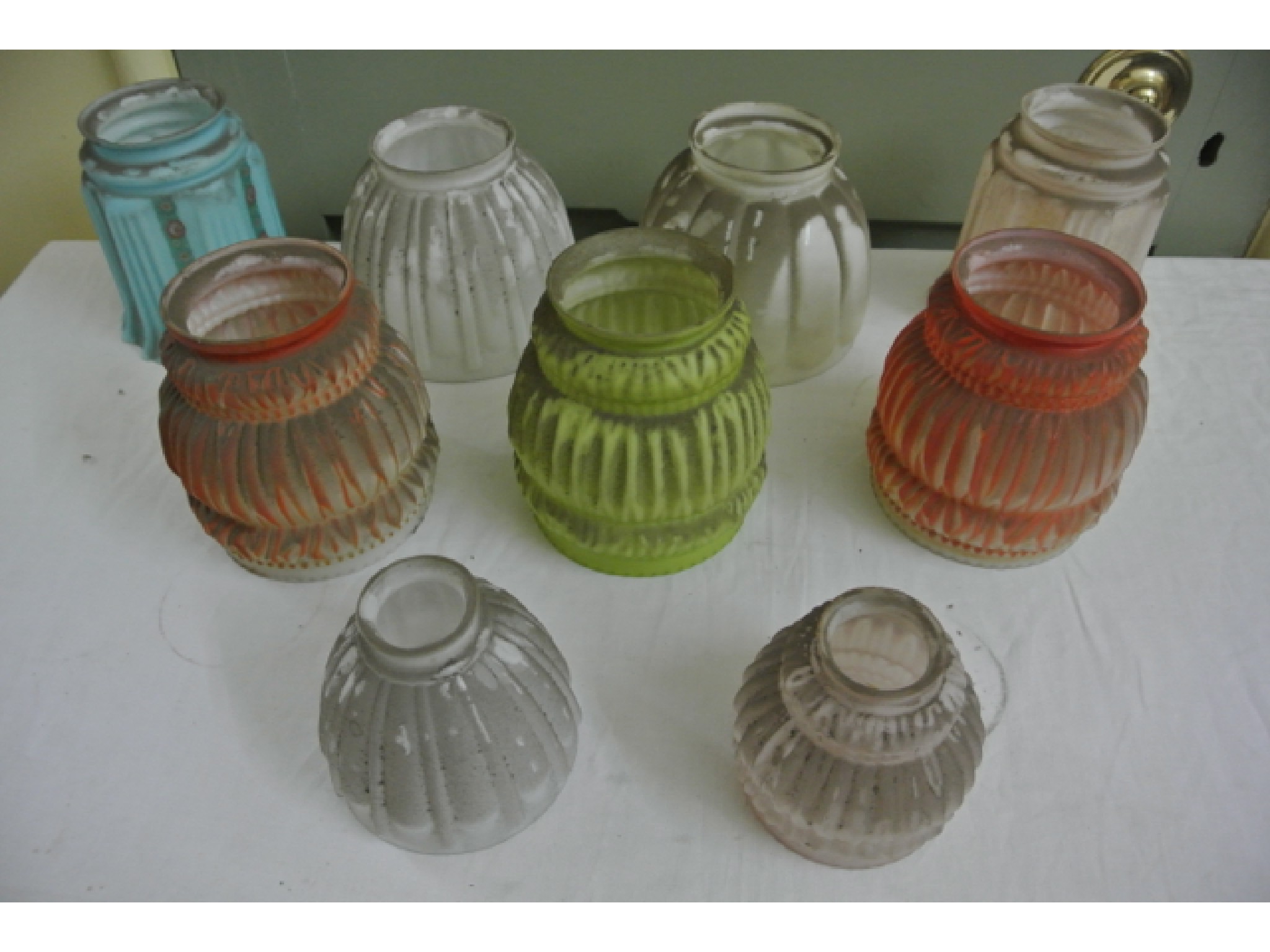 Appraisal: A pair of moulded coloured glass lightshades with pleated detail