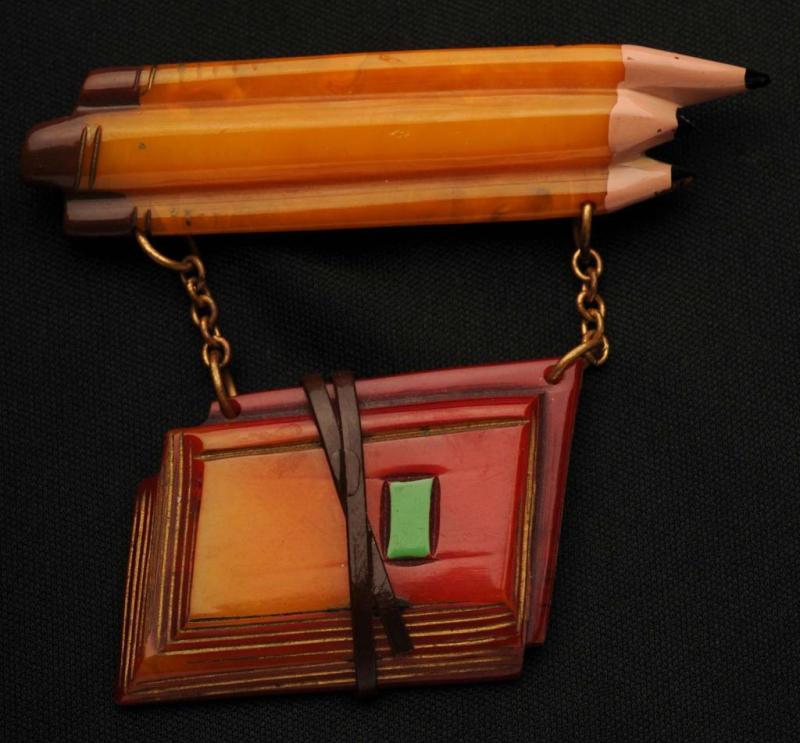 Appraisal: Bakelite Pencils with Hanging Books Pin Condition Excellent Size -