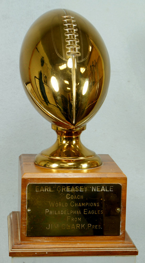 Appraisal: NFL brass trophy football on walnut base with applied engraved