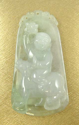 Appraisal: JADE CARVED PENDANT featuring a jolly figure riding a mule