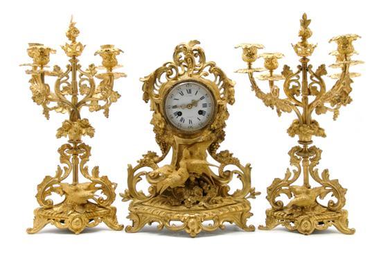 Appraisal: French Gilt Metal Three-Piece Clock Garniture the enameled circular dial