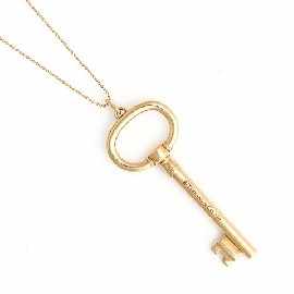 Appraisal: An ct gold key pendant on ct gold bead chain