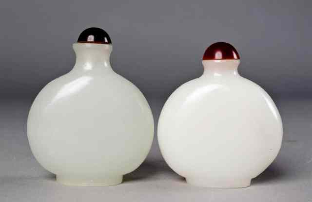 Appraisal: Chinese Carved White Glass Snuff BottlesOf opaque white with amber