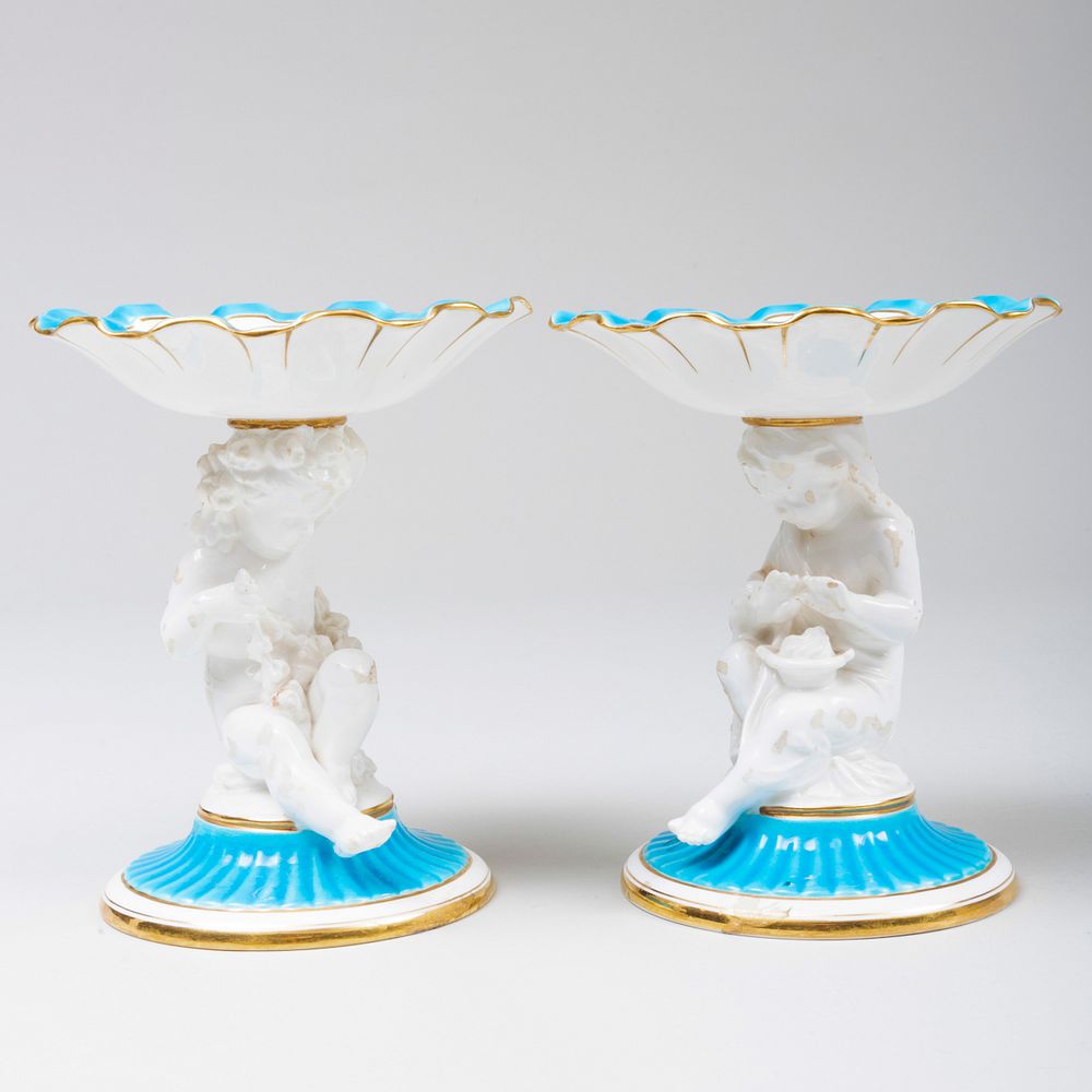 Appraisal: Pair of Minton Porcelain Compotes with Putti Supports Puce printed