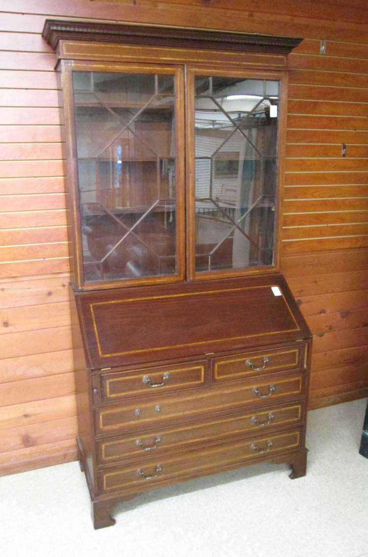 Appraisal: AN EDWARDIAN MAHOGANY SECRETARY BOOKCASE English c the slant-front desk