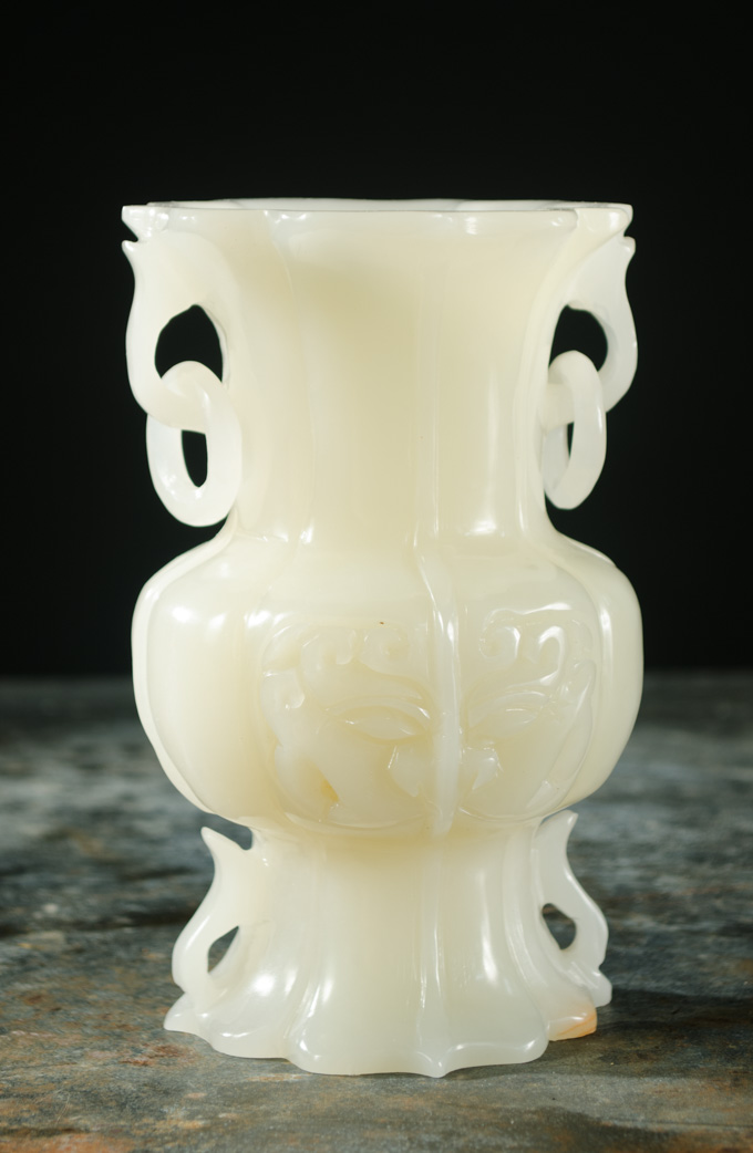 Appraisal: CHINESE CARVED JADE VASE light green color ring side handles