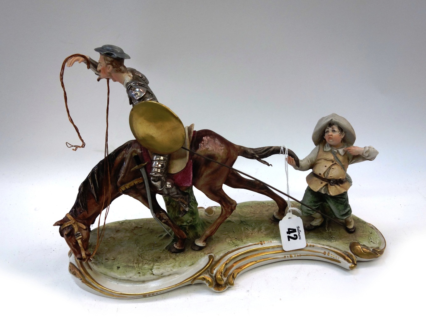 Appraisal: A Capo-di-Monte porcelain sculpture Don Quixote cm wide and a