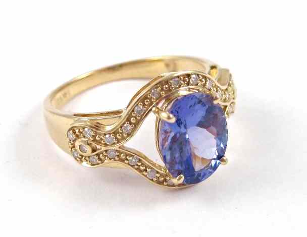 Appraisal: TANZANITE AND DIAMOND RING k yellow gold with round-cut diamonds